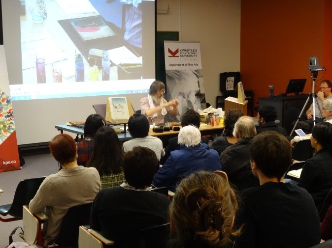 Audience watching close-up of printing technique